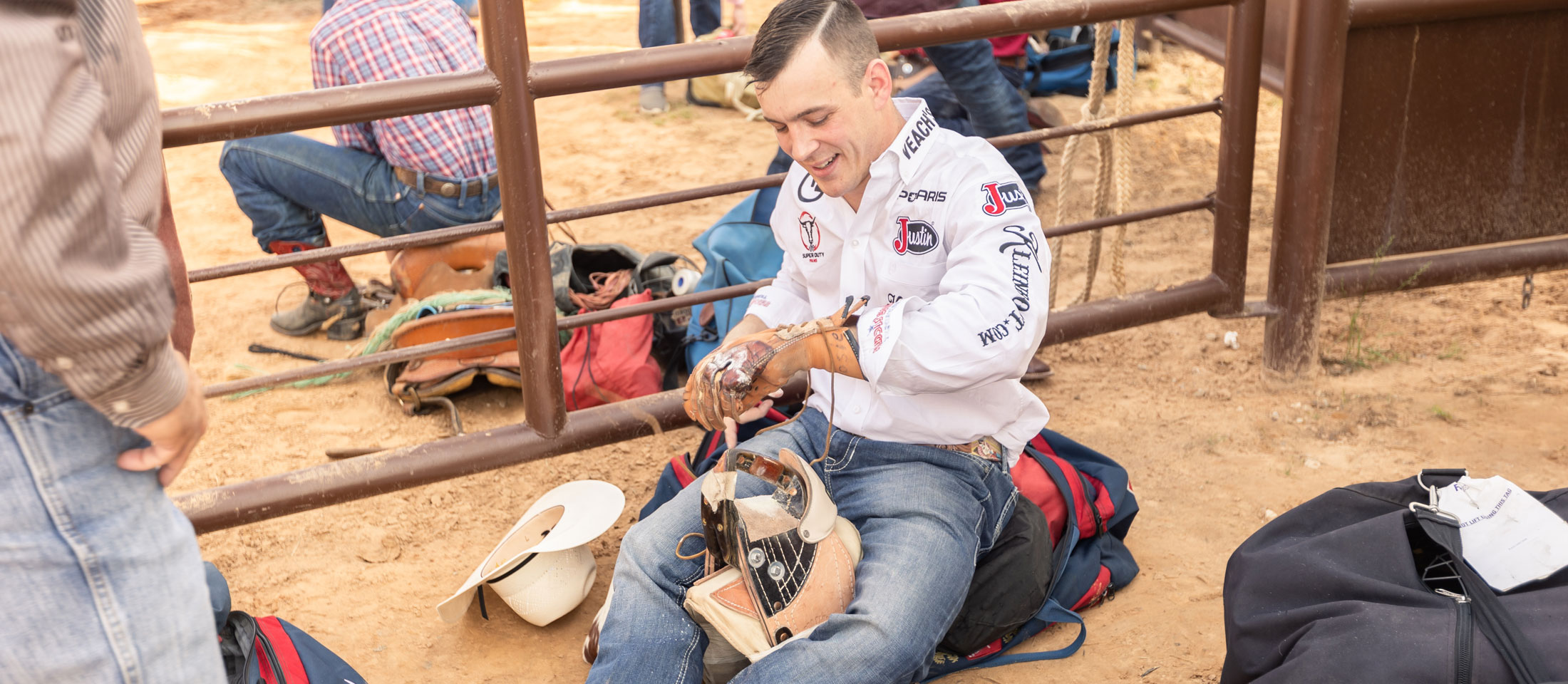 Bareback Rider, Tim O'Connell, putting rosin on his riding glove and warming up with his bareback riggin' before competing at a rodeo.